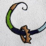 At the front of the megillah, the ribbon curls up, and a little crown hangs from it.